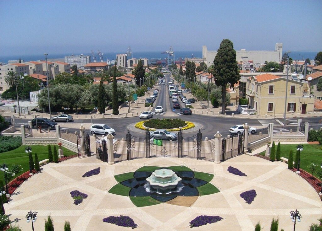 a fenced park with a fountain in the middle
